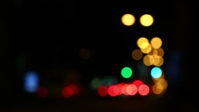 Defocused bokeh of colourful traffic lights of the night city road