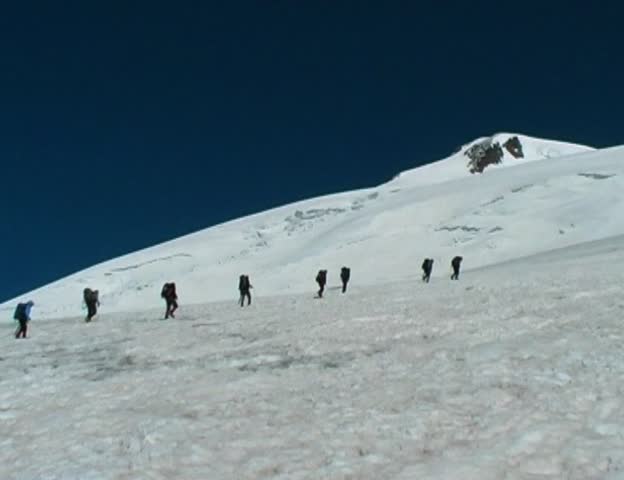 group of hikers go to the peak of Elbrus