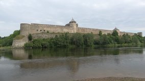 Ivangorod fortress and the Narva river, cloud day in august. Ivangorod, Russia