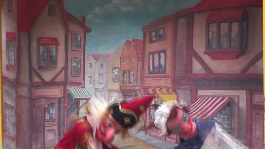 Punch and Judy puppets performing at a live show.