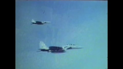 CIRCA 1977 - A McDonnell Douglas F-15 Eagle twin-engine tactical aircraft dogfights with a Northrop F-5E supersonic light fighter in an aerial combat maneuvering test 