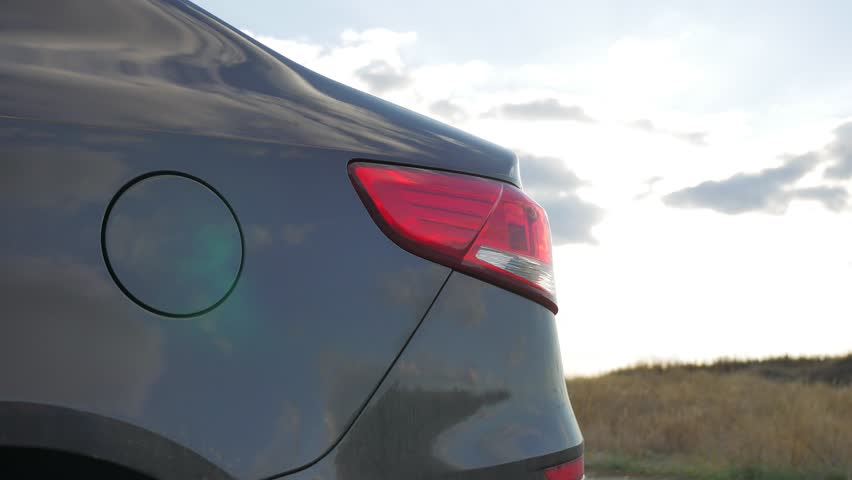 Rear-side view of a car on nature background