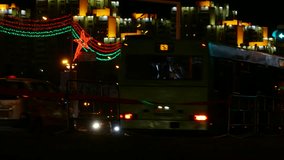 Ungraded: Cars drive through the night avenue with festive red and green illumination on the day of the 950th anniversary of Minsk. Ungraded H.264 from camera without re-encoding.