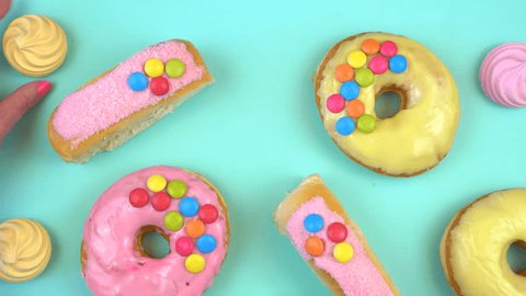 Pop Art Color style donuts and bakery goodies on bright colorful background overhead, time lapse. 스톡 비디오