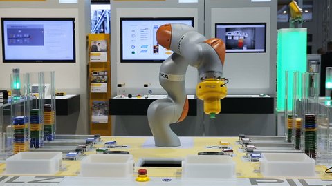 HELSINKI, FINLAND - OCTOBER 10, 2017: A compact industrial flexible robotic arm distributes objects by color. Latest technology in the field IoT, VR, AR, Big Data on the Trade Fair TEKNOLOGIA 17.
