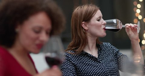 Female friends drinking red wine