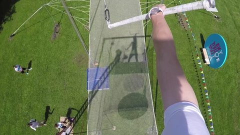 MOSCOW - MAY, 26, 2016: Man (first person view) wave on rope and fall in net on trapeze at Luzhniki. School of aerial gymnastics will open in Gorky Park in Moscow.