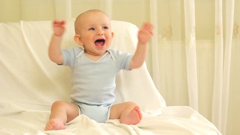 Adorable baby laughing and clapping hands
