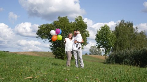Family launches balloons on the lawn