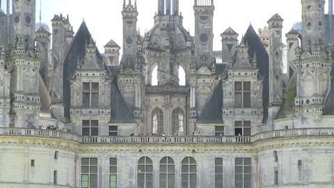 Chambord Castle, France during summer zoom out from roofs