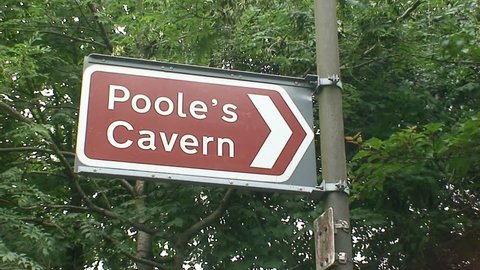 Tourist road sign pointing to Poole's Cavern in Buxton.