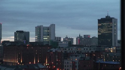 Timelapse shot of Manchester City Centre skyline as it goes dark and building lights are turned on.