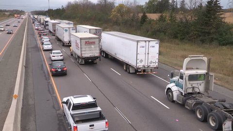 Guelph, Ontario, Canada October 2017 Tractor trailer trucks stuck in epic highway traffic jam and gridlock
