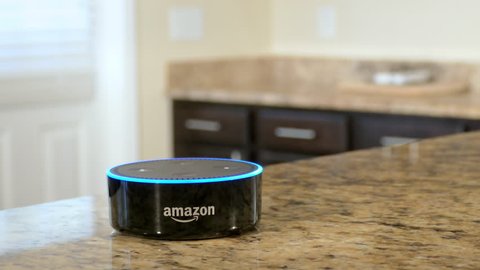 BOSTON, MA - OCT 12: Using Amazon Alexa Echo to control smart home lighting on October 12, 2017. The home automation market is predicted to reach a market value of $12.81 billion by the year 2020.