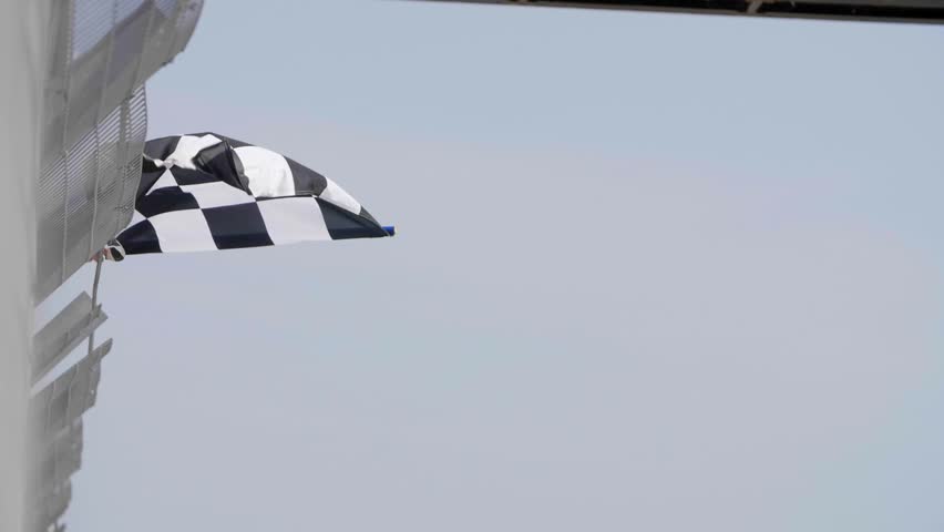 Man holding and waving Checkered race flag in slow motion at finish line on a raceway. Victory, achievement, success and sport concept. Royalty-Free Stock Footage #31709287