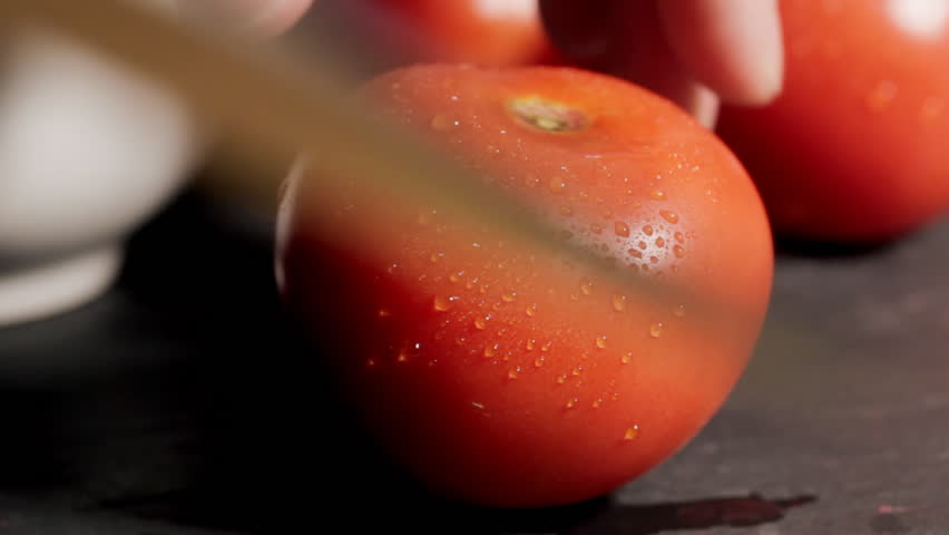 Chef cutting tomato