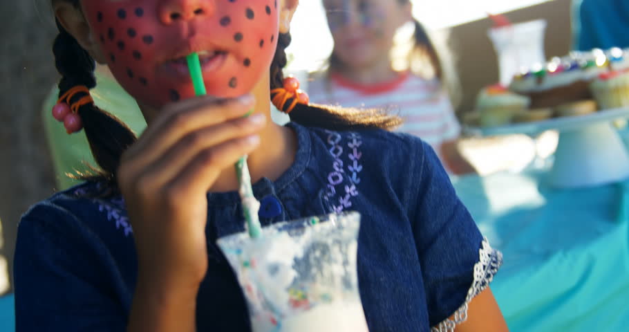 Happy giirl having drinks in the playground 4k