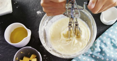 Overhead of woman whisking batter in a bowl 4k