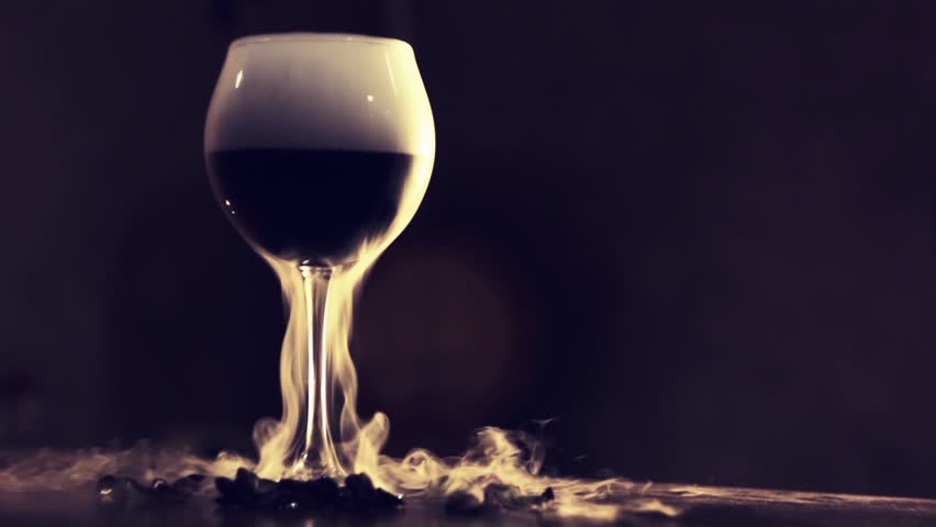 Red wine in glass with dry ice