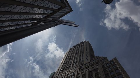 New York-circa 2017: Heavy traffic in the narrow streets of Manhattan, with stunning heights of blocks and bright advertising in the afternoon, on a sunny day, ultra hd4k, real time