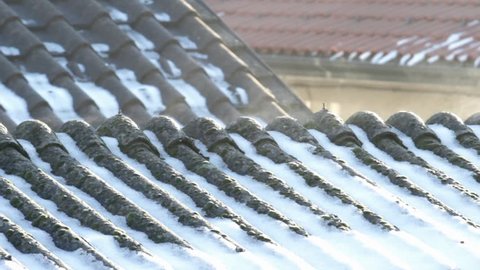 Evaporation on asbestos roof covering in the morning on a cold winter day 