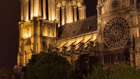 Famous landmark Notre Dame de Paris cathedral at twilight tilt and pan close-up video