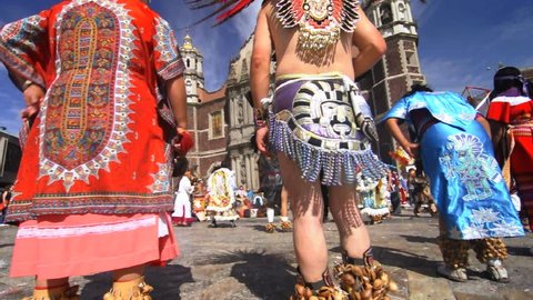 MEXICO CITY, MEXICO - DECEMBER 12, 2012: Aztec dance performers in traditional costume perform in the Plaza Mariana of the Basilica of the Virgin of Guadalupe in Mexico city on December 12, 2012.