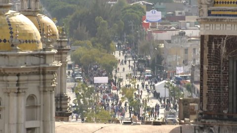 MEXICO CITY, MEXICO - DECEMBER 12, 2012: Zoom shot over old basilica from Tepeyac Hill reveals crowd of Catholics walking to the Plaza Mariana in Mexico City to visit the Virgin on December 12, 2012.