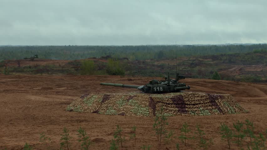 Russian tanks are driving through the field. Explosions. Burst. Military equipment. Military training