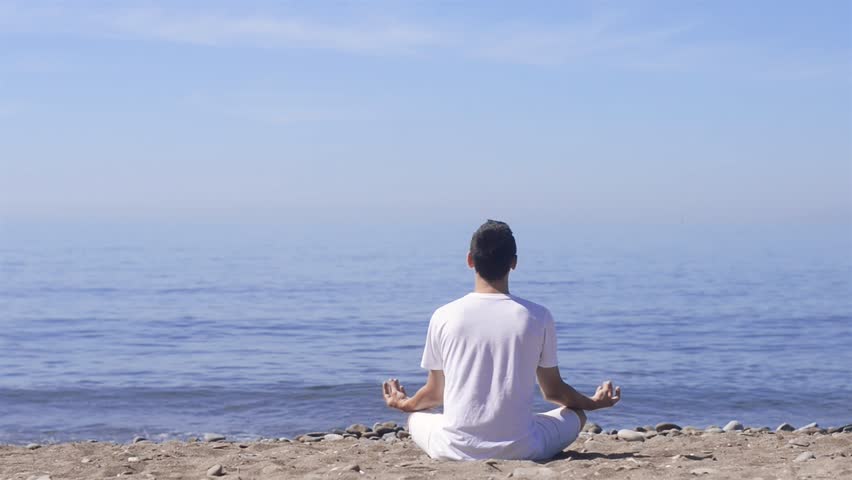 young man makes meditation lotus pose Stock Footage Video (100% Royalty ...