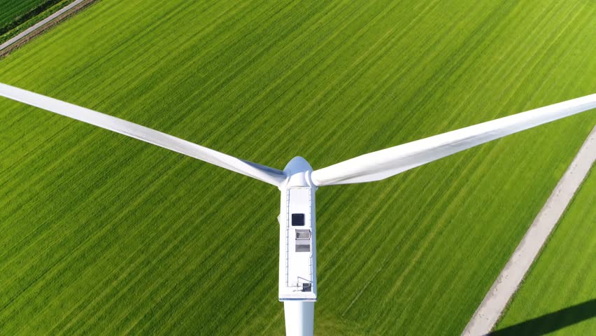 Aerial footage of wind turbine providing sustainable energy by spinning blades energy also known as renewable energy is energy that is collected from renewable resources such as wind or sun 4k Royalty-Free Stock Footage #31732321