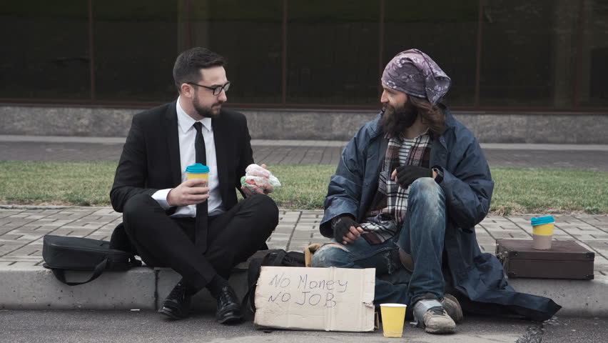 Businessman Eating Talking Poor Homeless Man: стоковое видео (без лицензион...