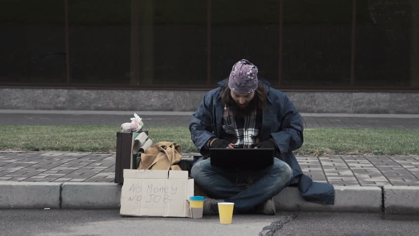 Funny homeless beggar using a laptop while receiving a good news as a surprising inheritance or winning a fortune after betting online Royalty-Free Stock Footage #31737484