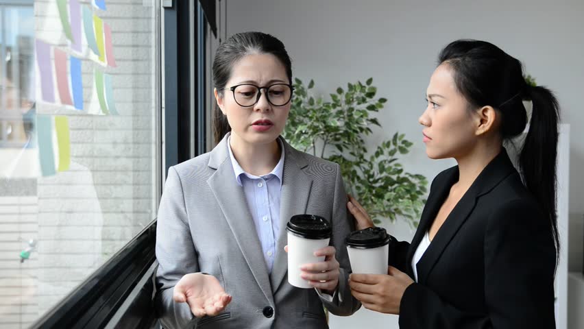 two Asian women have bad office experience talk and colleague help to relieve the pressure. Royalty-Free Stock Footage #31743223