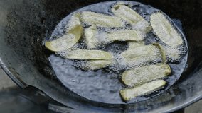 Banana deep frying on hot oil in a iron pan, Thai traditional food.