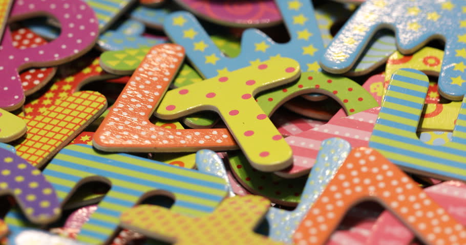 Colorful letters in rotation. Colorful background.