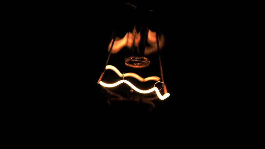 Close-up of a filament in the bulb (Blinking lamp, voltage fluctuations.)