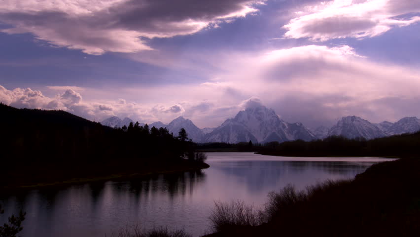 Grand Teton National Park - dramatic cloud formations over the mountain peaks with Snake river in the foreground at Oxbow Ben. 4K