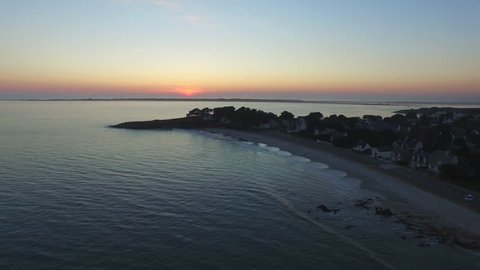 Flying over sunset on the beach of Ty Bihan. One of the five beaches of Carnac, Morbihan, Bretagne, France. Carnac is well-known for its famous rows of standing stones.
