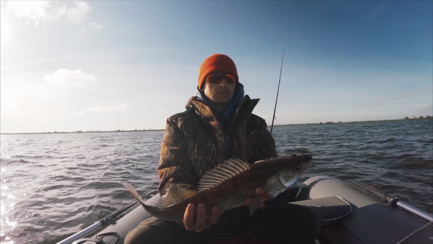 Amateur angler holds the Zander fish