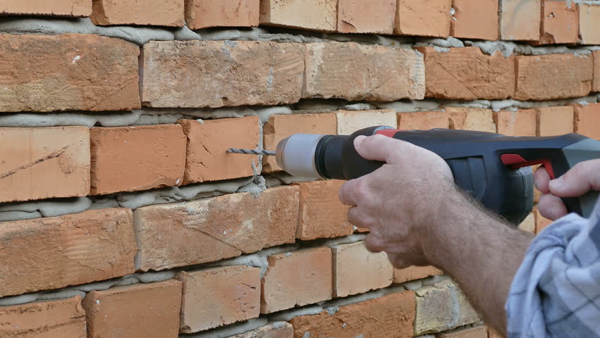 Drilling Hole Brick Wall Using Electric Stock Footage 100 Royalty Free 31757710 Shutterstock - How To Drill A Hole In The Brick Wall