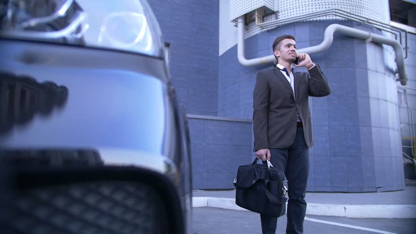 Young perspective businessman talk on mobile, stands beside with fashionable car Royalty-Free Stock Footage #31760176