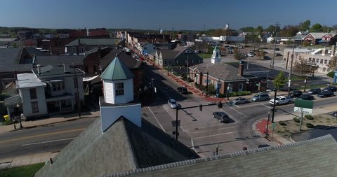 A day dolly aerial establishing shot of the small town of Salem, Ohio's business district.  	