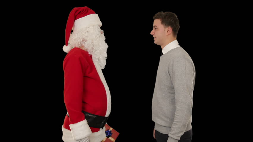 Young Businessman receiving a present from Santa Claus, shaking hands, against