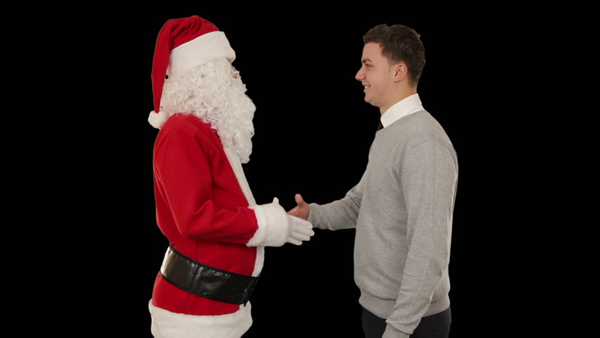 Santa Claus and Young Businessman against black, shaking hands and looking at