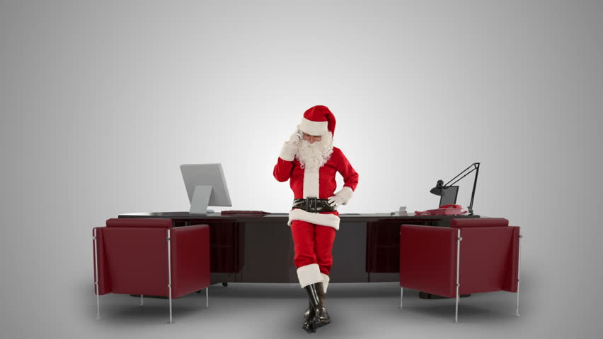 Santa Claus on mobile in his modern Christmas Office, against white