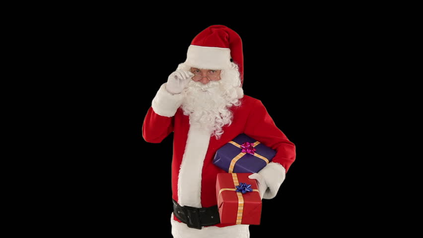 Santa Claus holding presents, against black