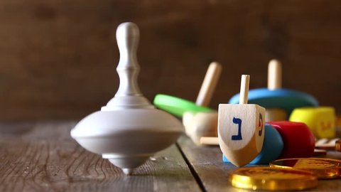 jewish holiday Hanukkah footage with traditional wooden spinnig dreidel (spinning top)