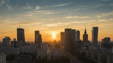 Sunrise over Warsaw downtown skyline with skyscrapers, Poland. Time lapse at dawn
