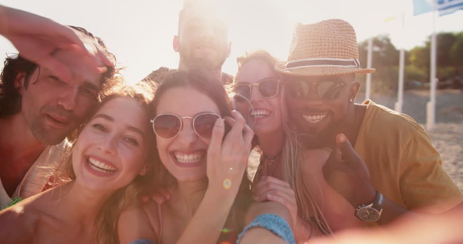 Young multi-ethnic hipster friends on summer island holidays video chatting using smartphone at the beach | Shutterstock HD Video #31788502